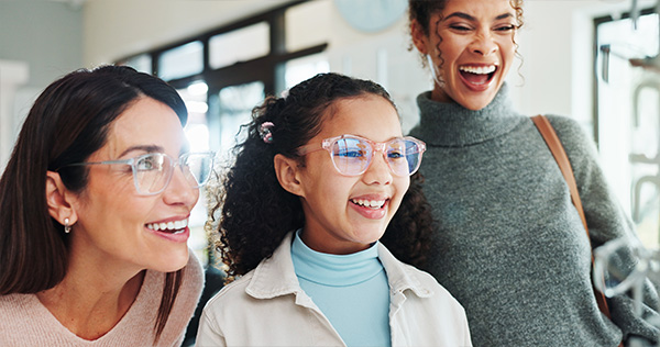Family at the optometrist trying on glasses