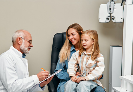 Mom and daugther in eye exam room with optometrist