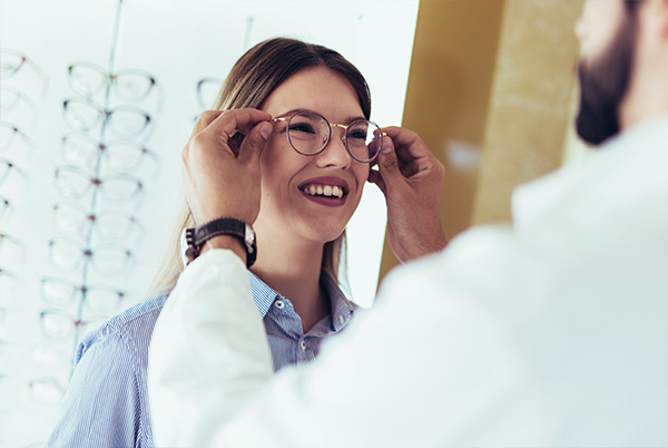 Trying on glasses in optical boutique